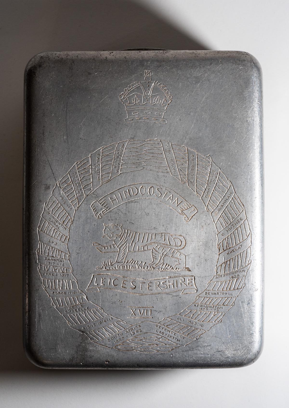 Mess tin engraved with the Regimental crest on the base, by Major Dobson while a prisoner of war in Thailand.